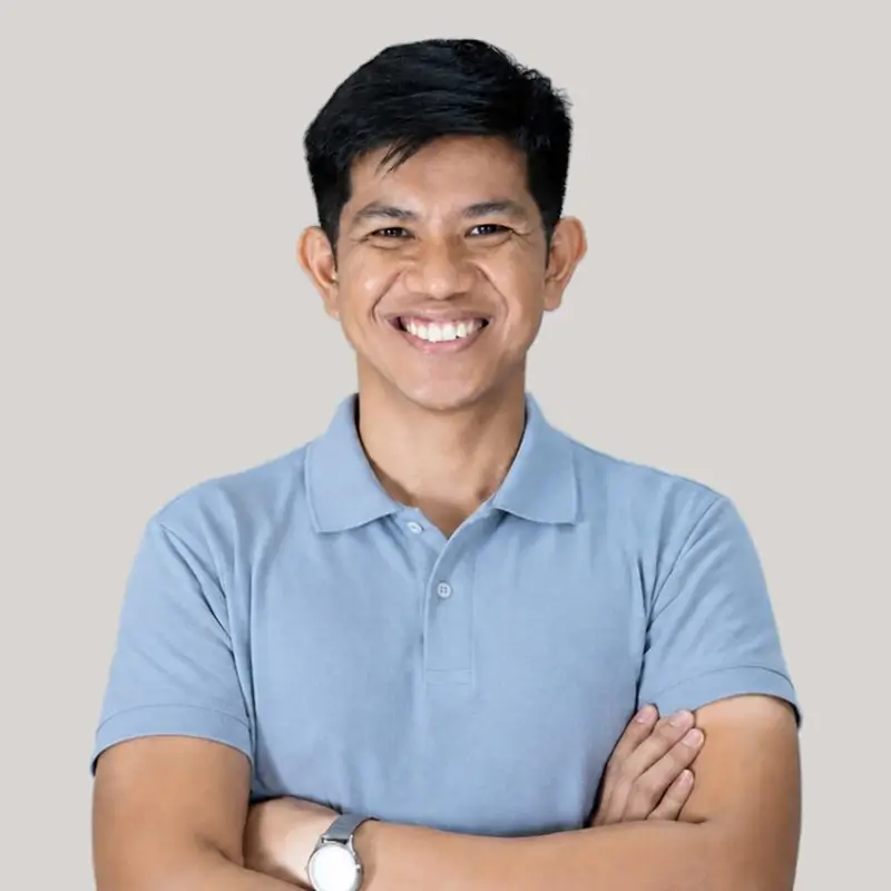 Ian Mata smiling with his arms crossed